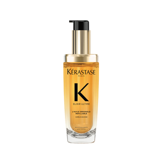 A clear glass bottle with a pump dispenser, containing yellow-hued hair oil, labeled Kérastase Elixir Ultime L'Huile Originale.