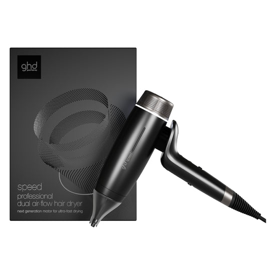 Black hair dryer with ghd logo next to its packaging on a white background